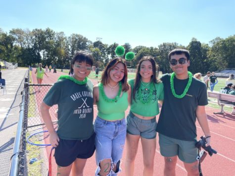 Four students dressed in green on the track.