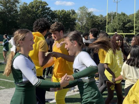 students dance on the football field.