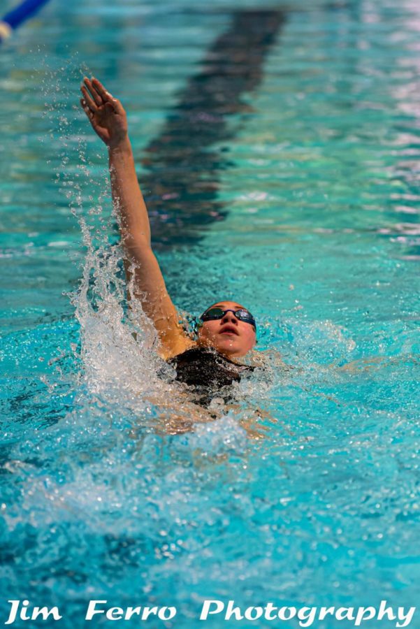 Sophia Rodas (11) backstrokes down the pool.