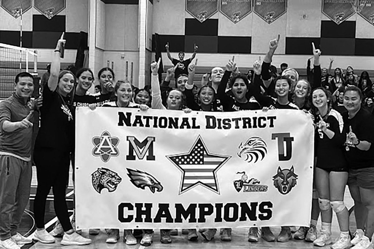 The volleyball team and coaches celebrate their district victory against Thomas Jefferson High School for Science and Technology.