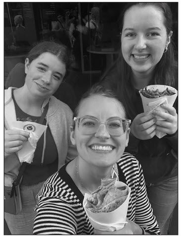 Kathryn Rubin (10), Sasha Wendell (10), and Madame Herodet
eating crepes on the street in Paris. Trying new foods was a
favorite memory for some of the students.